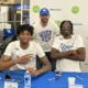 Aaron Bradshaw and Jordan Burks taking a picture with a Kentucky Basketball fan