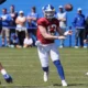 Kentucky QB Devin Leary throws the ball past J.J. Weaver (#13) during open practice
