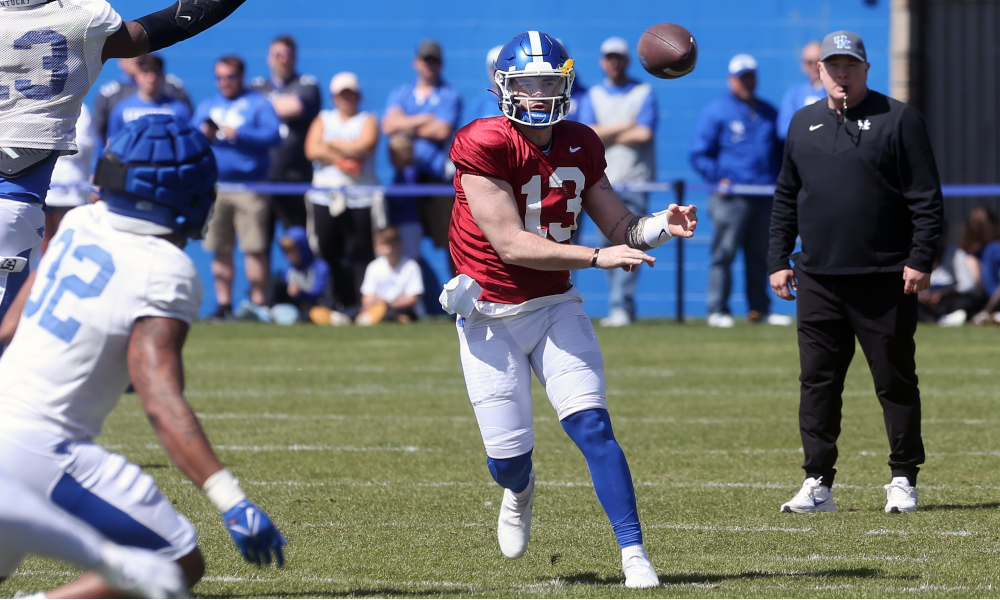 Kentucky QB Devin Leary throws the ball past J.J. Weaver (#13) during open practice
