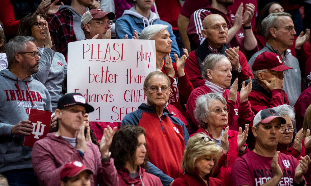 An Indiana fan holds a sign referencing Purdue's men's basketball team during the first round of the NCAA women's tournament at Simon Skjodt Assembly Hall.