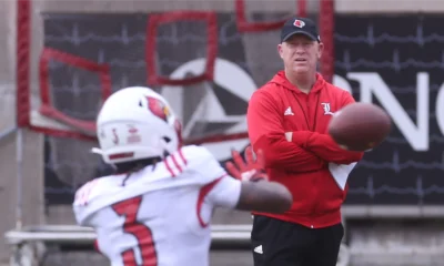 Louisville football coach Jeff Brohm watches Kevin Coleman catch the ball during the Cardinals' open practice