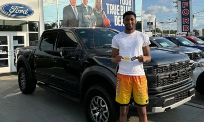 Kentucky freshman forward Justin Edwards standing beside his new Ford F-150 Raptor from an NIL deal with Paul Miller Ford.