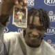 Los Angeles Clipper Terance Mann holding a Rajon Rondo Kentucky card that he keeps for good luck.