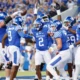Kentucky Wildcat football team celebrating in the endzone at Kroger Field.