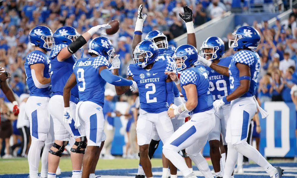 Kentucky Wildcat football team celebrating in the endzone at Kroger Field.