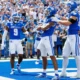 Tayvion Robinson and Brenden Bates celebrating with Dane Key after a Kentucky touchdown at Kroger Field.
