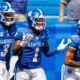 Kentucky Wildcats running back Ray Davis (1) celebrates a touchdown with wide receiver Dekel Crowdus (3) and wide receiver Anthony Brown (5) during the fourth quarter against the Ball State Cardinals at Kroger Field.
