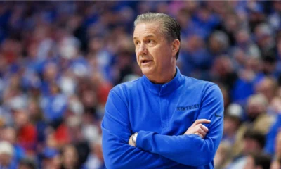 Kentucky basketball coach John Calipari with his arms crossed as he observes his team at Rupp Arena.