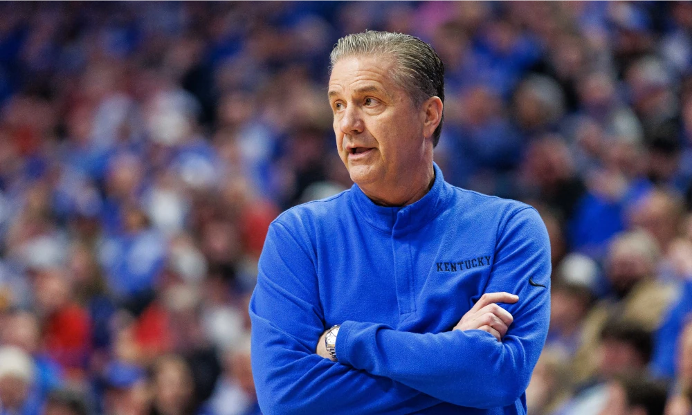 Kentucky basketball coach John Calipari with his arms crossed as he observes his team at Rupp Arena.