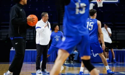John Calipari standing on the Rupp Arena floor during Kentucky Basketball Pro Day.