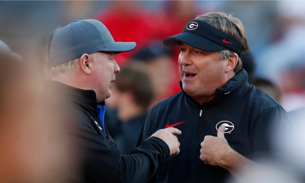 Georgia coach Kirby Smart speaks with Kentucky coach Mark Stoops before the start of a NCAA college football game against Kentucky in Athens, GA.