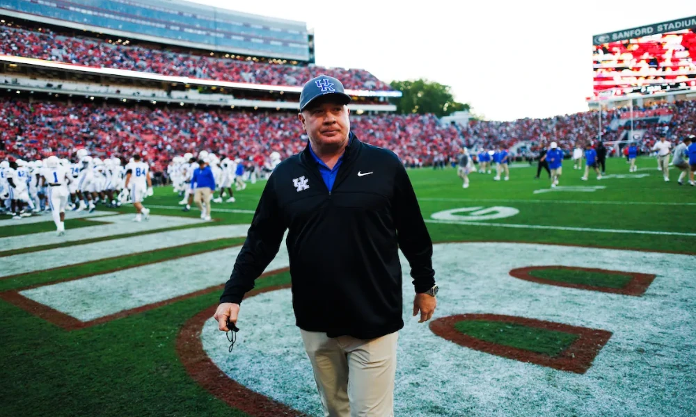 Mark Stoops walking the field ahead of Kentucky's matchup against Georgia.