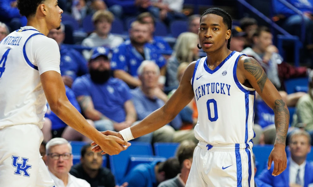 Kentucky Wildcats guard Rob Dillingham (0) fives forward Tre Mitchell (4) during the first half against the Georgetown Tigers at Rupp Arena.