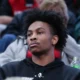 Former Louisville Cardinal basketball player Koron Davis watches from the stands of the KFC Yum Center.