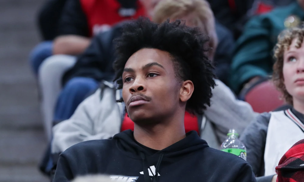 Former Louisville Cardinal basketball player Koron Davis watches from the stands of the KFC Yum Center.