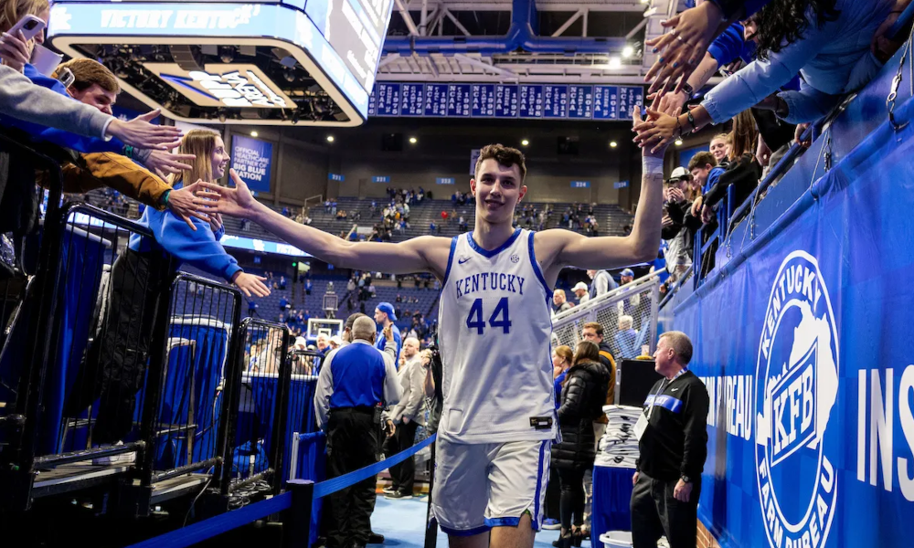 Kentucky Wildcats center Zvonimir Ivisic celebrates with Kentucky fans at Rupp Arena after his impressive debut.