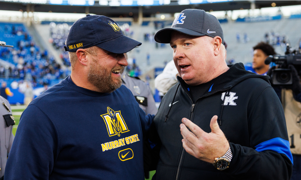 Kentucky football coach Mark Stoops talking to Murray State football coach Jody Wright.