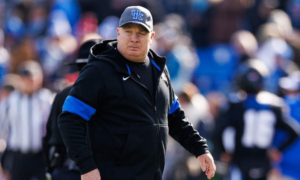 Kentucky Wildcats head coach Mark Stoops walks onto the field before the game against the Louisville Cardinals.