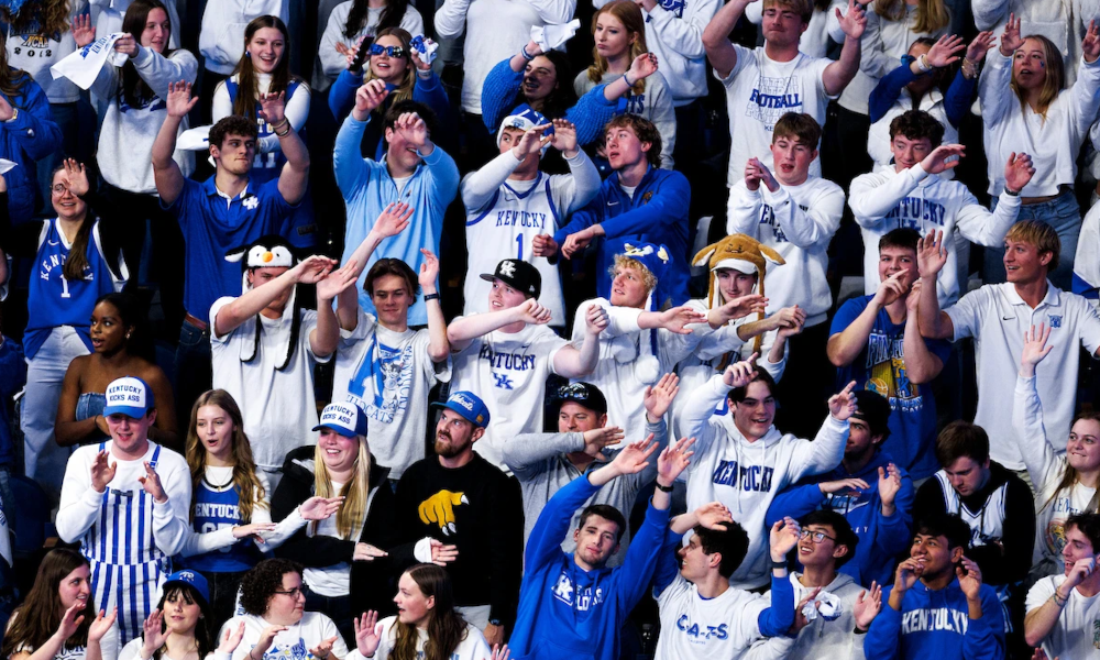 Kentucky fans standing and cheering during Kentucky-Louisville game.