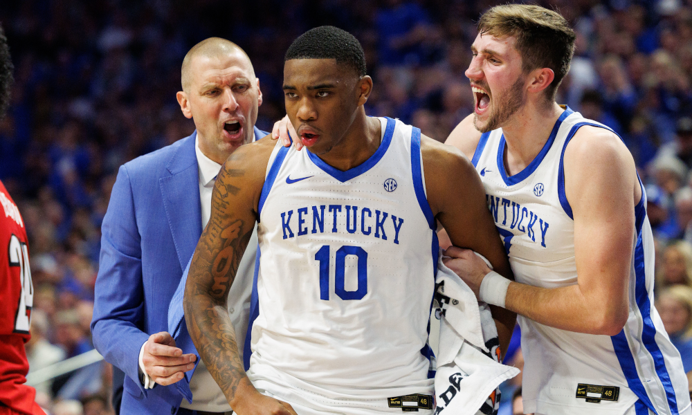 Kentucky Wildcats head coach Mark Pope and forward Andrew Carr (7) celebrate with forward Brandon Garrison.