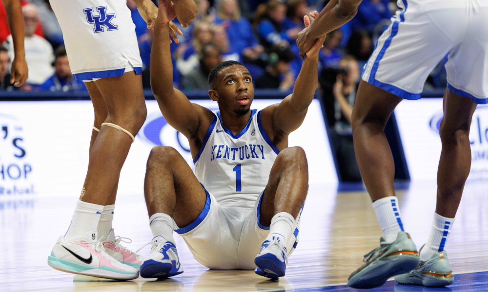 Kentucky Wildcats guard Lamont Butler (1) is helped to his feet by his teammates.