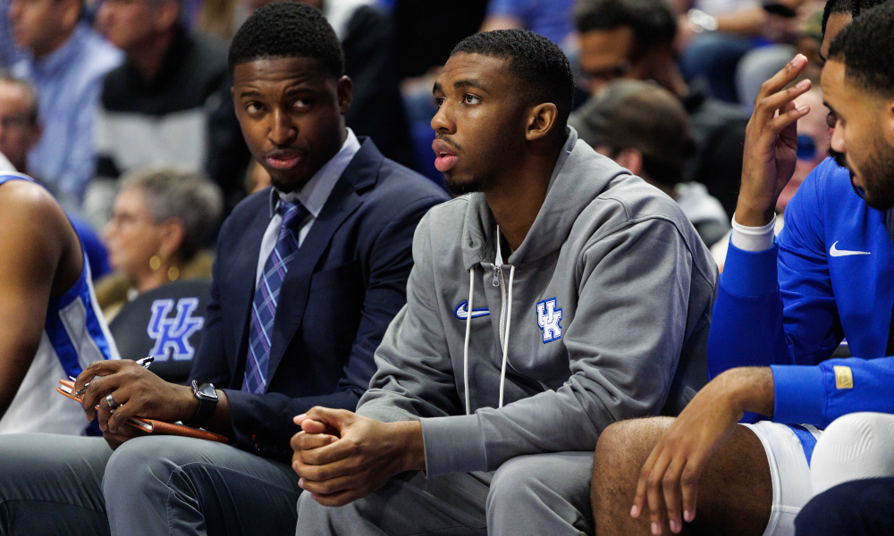 Kentucky Wildcats guard Lamont Butler watches the action from the bench, out with an injury.