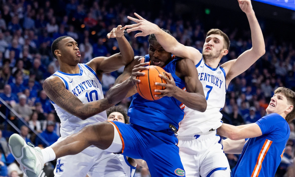 Kentucky's Brandon Garrison and Andrew Carr go up for a rebound against Florida.