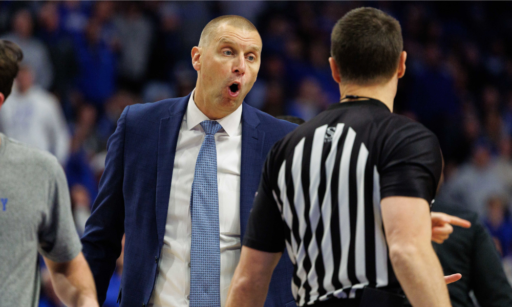 Kentucky Wildcats head coach Mark Pope talks with a referee at Rupp Arena.