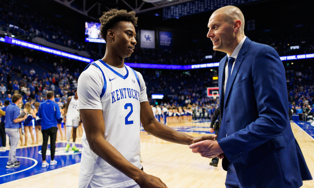 Jaxson Robinson and Mark Pope celebrate after a win at Rupp Arena.