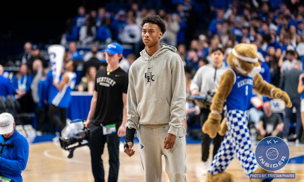 Kentucky guard Jaxon Robinson watching warmups as he sits with an injured wrist.