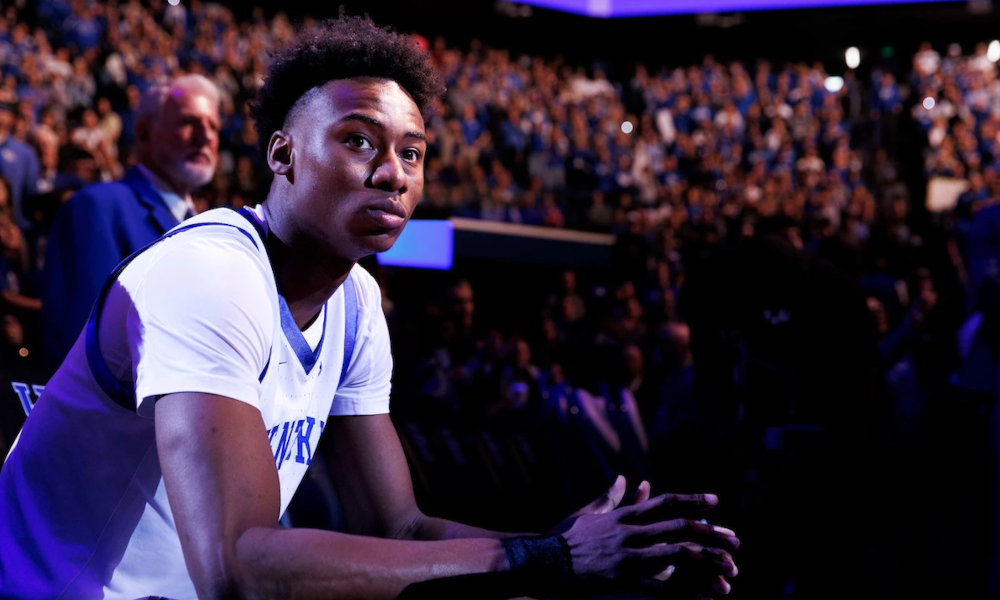 Kentucky guard Jaxson Robinson sitting on the bench as they announce the starters at Rupp Arena.