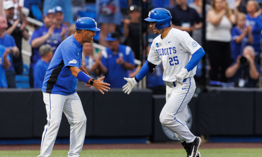 Kentucky Wildcats infielder Ryan Nicholson (25) fives Kentucky Wildcats head coach Nick Mingione after hitting a home ru