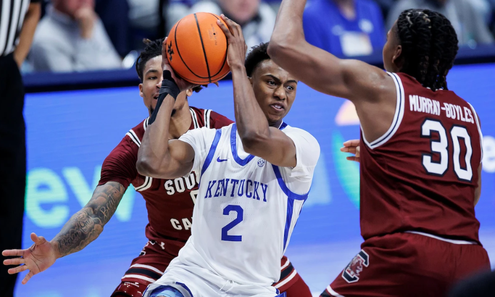 Kentucky guard Jaxson Robinson keeps the ball away from South Carolina defenders.