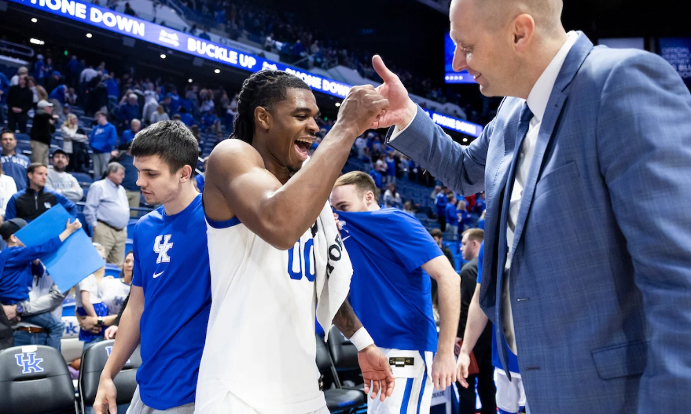 Kentucky guard Otega Oweh and coach Mark Pope celebrate after Kentucky's win over South Carolina.