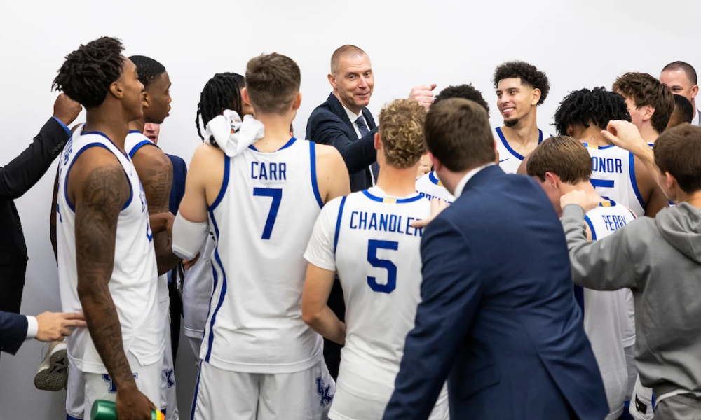 Kentucky head coach Mark Pope celebrates with his team in the locker room.