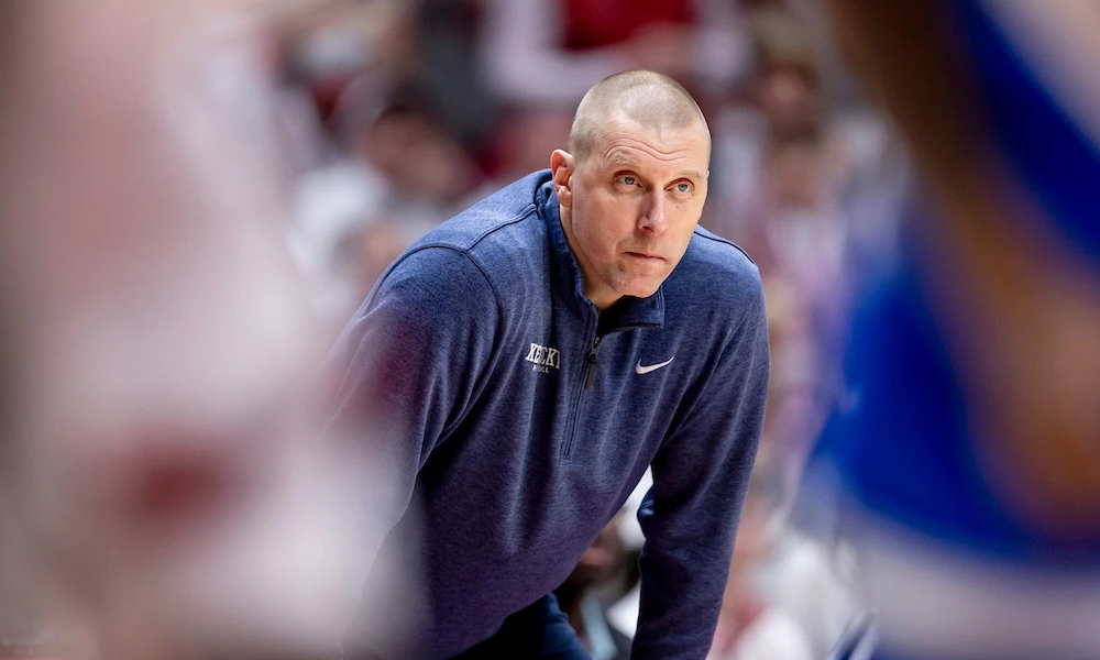 Mark Pope bends over in frustration as the Kentucky Wildcats take on Alabama.