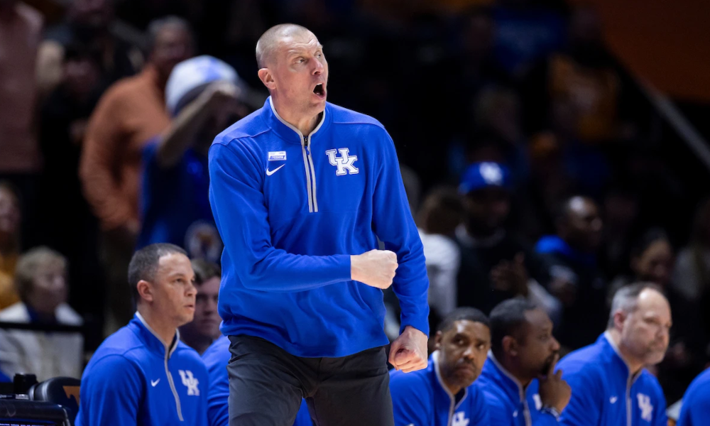 A frustrated Mark Pope yells at an official during a Kentucky basketball game.