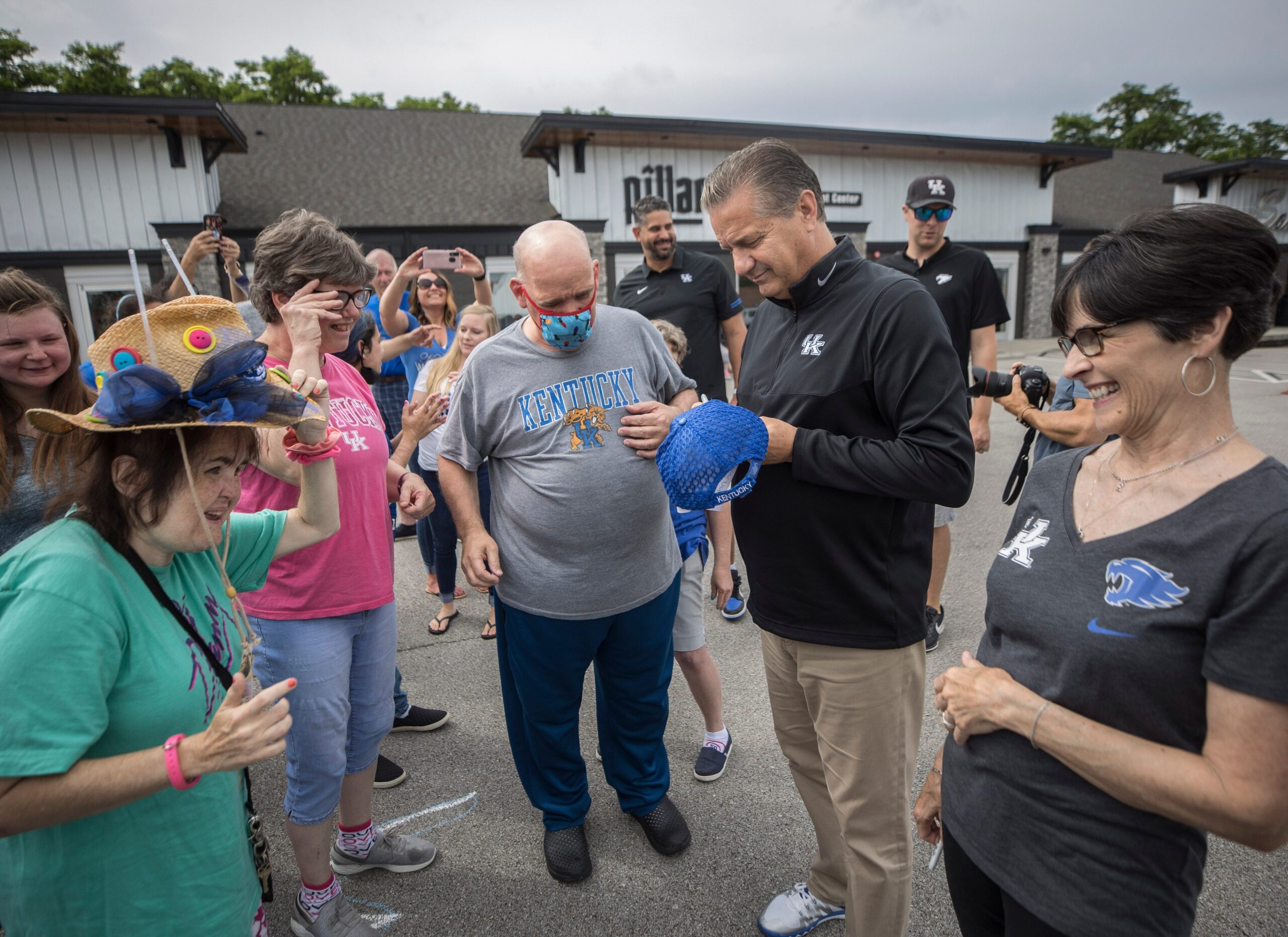 John Calipari and wis wife Ellen visit people in the community.