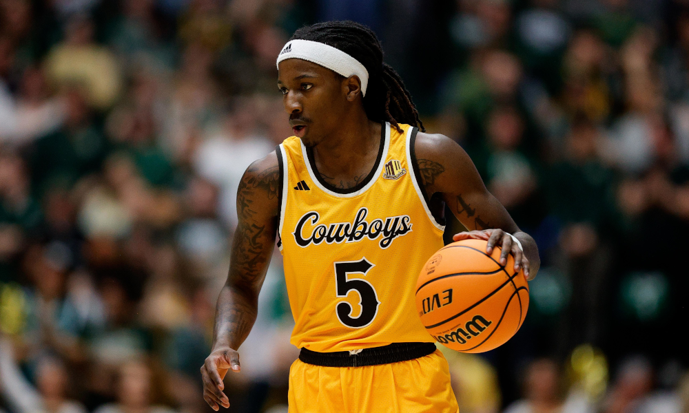 Wyoming Cowboys guard Obi Agbim (5) dribbles the ball up court.