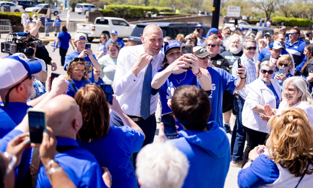 Kentucky head coach Mark Pope takes photos with fans.